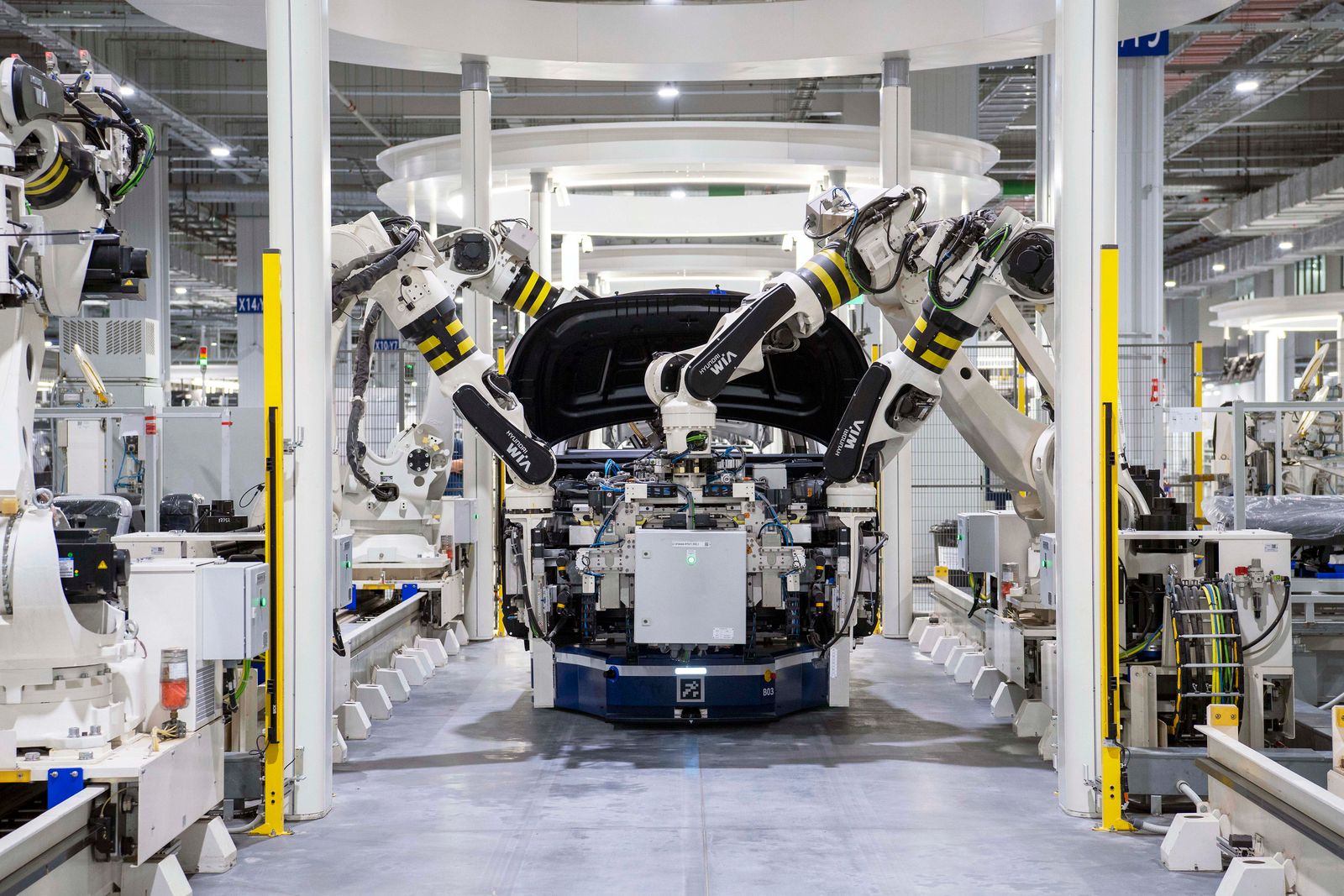 Robotic arms assembling a car body in an automotive plant