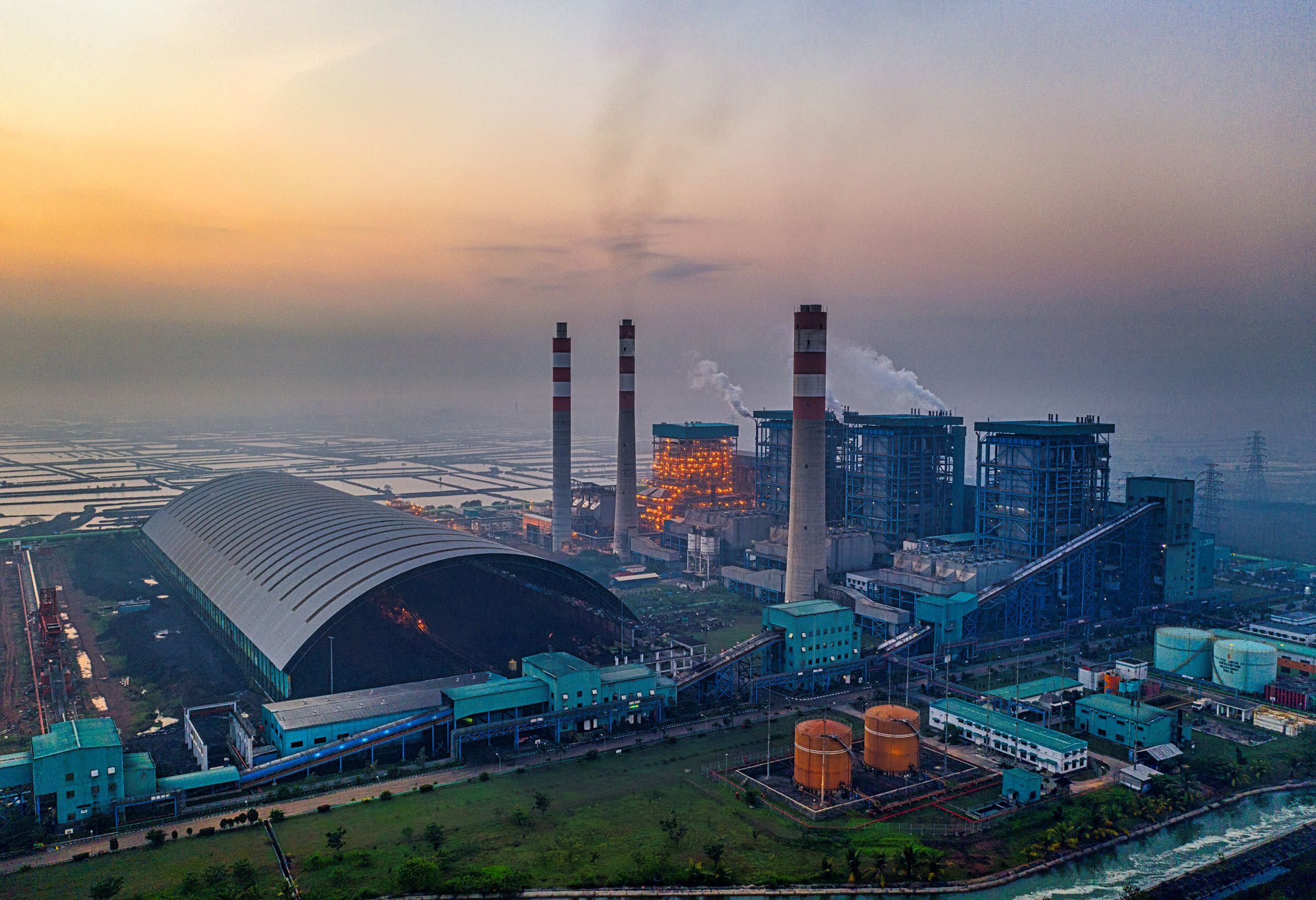 An aerial view of a large power station at dusk